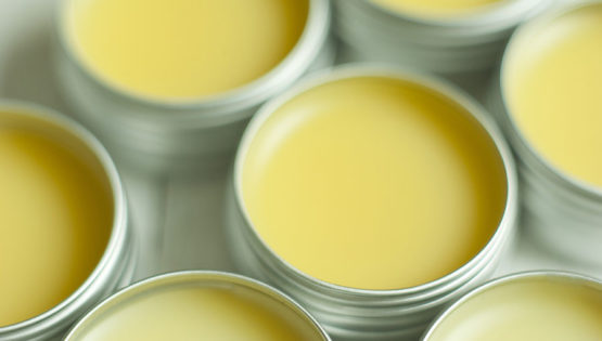 open containers of yellow hand balm