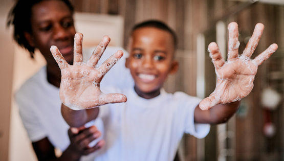 Father holding kid with Jammin Jelly handwash on hands