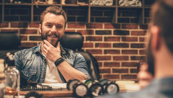 Man Stroking Beard and Smiling