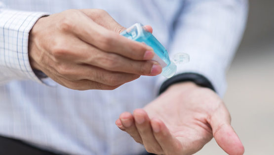 Man Sanitizer Getty Images 1209446082