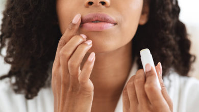 Woman applying Still Care Lipwear to her lips
