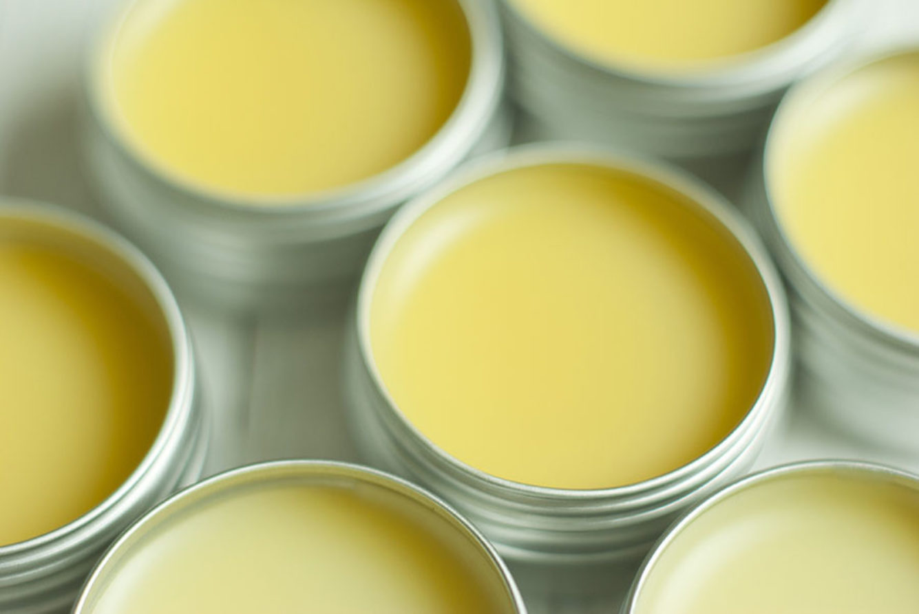 open containers of yellow hand balm
