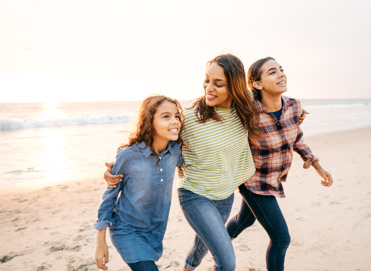 A woman and two children on a beach