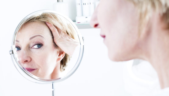 Woman Looking Into Mirror