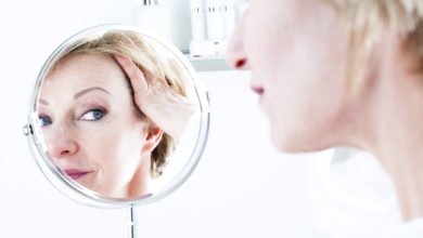 Woman Looking Into Mirror