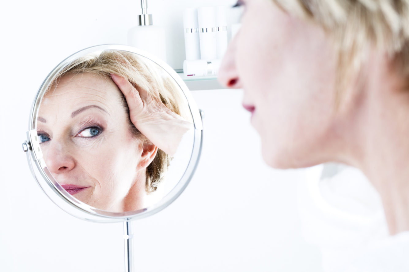 Woman Looking Into Mirror